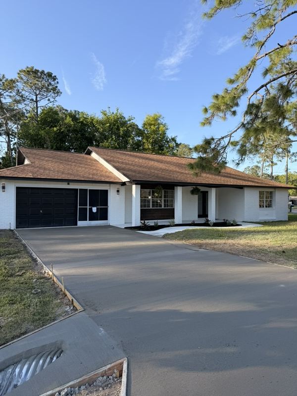 The new concrete driveway at the same Palm Coast flip after the pour