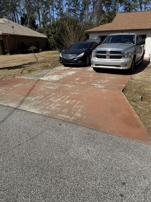 The old cracked red driveway at a Palm Coast flip before it was replaced