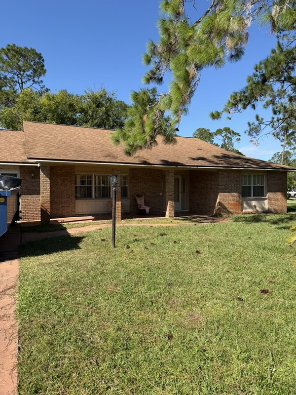 A Palm Coast flip with its old red brick exterior before painting