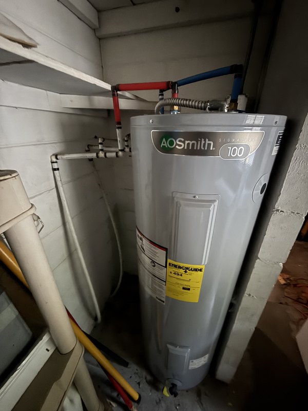 A new electric water heater with new supply lines in a Palm Coast flip